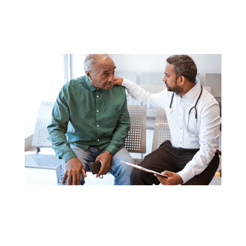 A doctor speaking with an older patient in a clinic waiting area